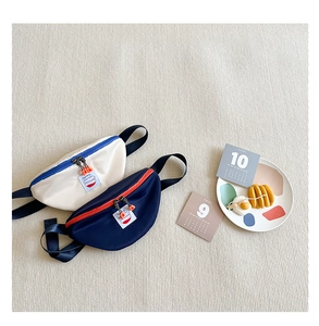 Close-up of kids canvas waist bags with cartoon patches and adjustable straps