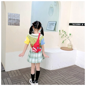 Rear view of a child wearing a cute red shark canvas crossbody bag with adjustable strap