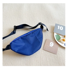 Close-up of blue mesh fabric waist bag for kids with adjustable black nylon strap and buckle