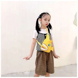 Detail of yellow shark canvas chest bag on child showing the adjustable strap and cute design