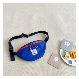 Close-up of kids blue nylon fanny pack with orange zipper and Sunny patch detail