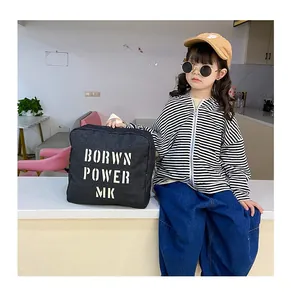 Kids casual street style denim outfit featuring striped hoodie and printed canvas bag