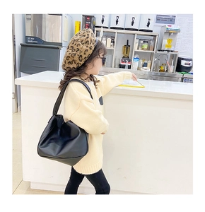 Fashionable black leather dumpling crossbody bag for girls with wide shoulder strap detail