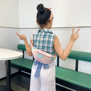 Kids colorful tie-dye PU crossbody bag shown on child model in a bright indoor setting