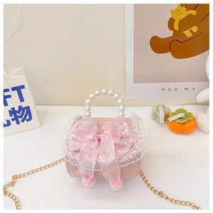 Detail of pink lace girl handbag with sequin bow crown and pearl handle design