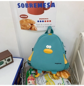 Detailed view of a cute teal canvas duck backpack styled in a snack basket setting