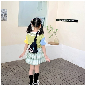 Rear view of a child wearing a black cartoon shark chest bag with canvas material