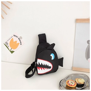 Detail of shark eyes and jagged teeth patterns on a black canvas kids chest bag