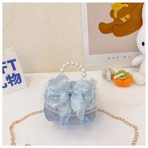 Detail of light blue girl's bag with floral fabric, sequined bow, and pearl handle