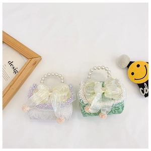 Close-up of girls mini princess bags with large bows and elegant pearl handles