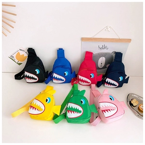 Detail showing seven vibrant colors of children's shark-shaped canvas crossbody chest bags
