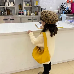 Girl's bright yellow faux leather half-moon crossbody bag with wide shoulder strap