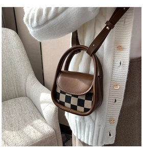 Mini checkered leather crossbody bag shown in a cozy autumn-themed lifestyle scene
