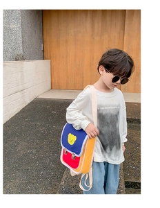 Photo en extérieur d'un sac à dos pour enfant en toile colorée avec motif d'ourson