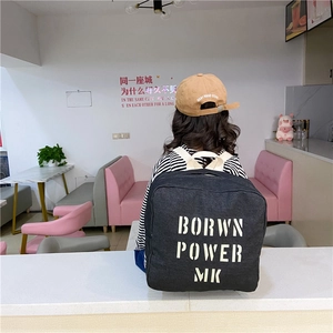 Kids black denim backpack with white Born Power letters and cream straps for daily school