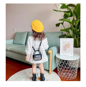 Detailed view of mini houndstooth crossbody bag for girls with leather handle and strap