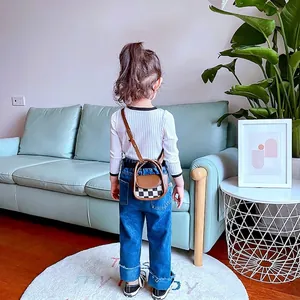 Mini checkerboard kids crossbody bag in brown leather with a classic black and white flap