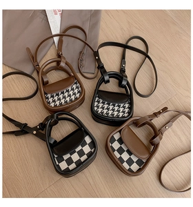 Detail view of mini retro stirrup bags in houndstooth and checkerboard patterns