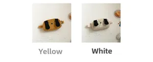 Detail of yellow and white canvas dog-shaped belt bags for boys with cute 3D ears