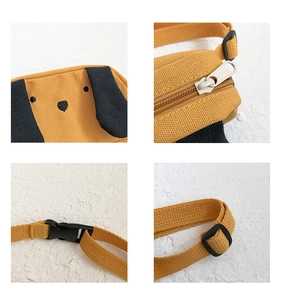 Detail view of yellow canvas kids bag showing smooth zipper and plastic buckle