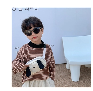 Kids off-white canvas crossbody bag featuring a cartoon puppy worn by a young boy