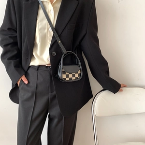 Miniature black and yellow checkerboard crossbody saddle bag with adjustable strap