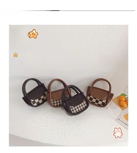 Detailed display of four mini checkered and houndstooth patterned handbags for kids