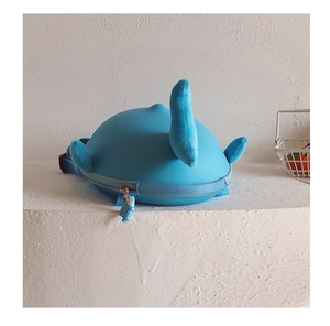 Close-up of blue whale toddler backpack with soft fins and fish-shaped zipper pull detail