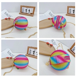 Detail of glitter rainbow spherical crossbody bag with golden chain and rabbit charm