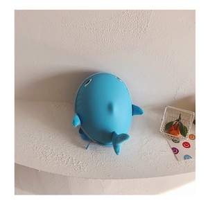Detail of blue whale hard shell toddler backpack with soft plush fins and tail details