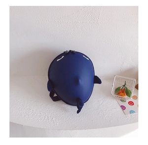 Detail of shark backpack featuring 3D fins, embroidery, and durable hard shell texture