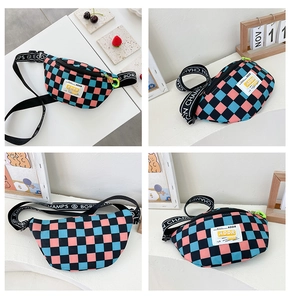 Detail showing colorful checkerboard kid chest bag with ADDR tag and green charm hook