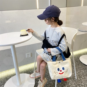 Kids cream canvas tote bag with cute cartoon smiley face and 3D feet decorations