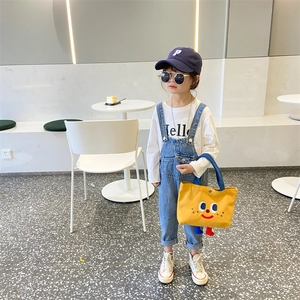 Kids yellow cartoon face canvas handbag styled with denim overalls and a baseball cap