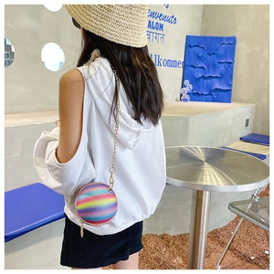 Close-up of rainbow glitter mini crossbody bag with gold chain strap on model back