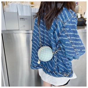 Detail of mint green checkered round bag with gold chain and cute rabbit charm