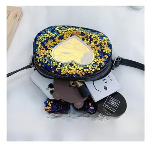 Detail view of the interior capacity of a sequined heart crossbody bag for girls