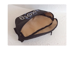 Detail shot of the black canvas bag showing its beige fabric lining and zipper closure