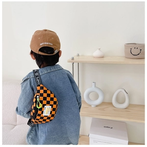 Detail of kids checkerboard chest bag with printed straps and street style fashion
