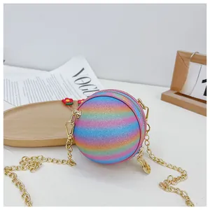 Close-up of rainbow glitter ball bag with golden chain and zipper for kids