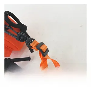 Detail of adjustable nylon strap with black plastic hook on orange mini canvas bag