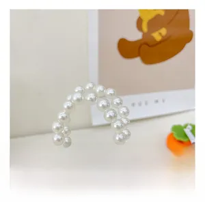 Macro view of double-layered faux pearl shoulder strap for kids beaded handbag