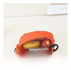 Internal view of the orange mini crossbody bag showing storage space for small items