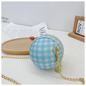 Detail of light blue checkered ball-shaped bag with glitter finish and gold chain