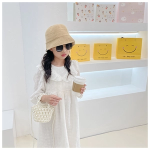 Girl's white beaded pearl handbag styled with a lace dress for a fresh holiday look