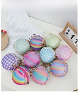 Detail view of colorful glitter mini round bags with gold chain straps and metal zippers