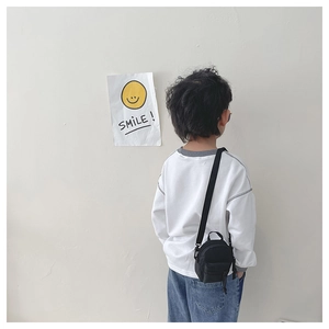 Mini black canvas crossbody bag for kids with double zipper layers and adjustable strap