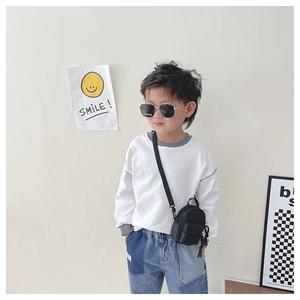 Asian boy model wearing a black nylon mini crossbody bag with a casual outfit