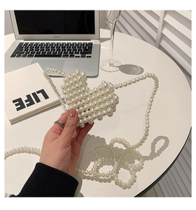 Close-up of heart-shaped woven pearl crossbody bag for girls with matching pearl chain