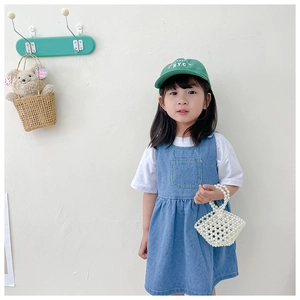 Blue denim overall dress for girls paired with a luxury pearl beaded handmade handbag